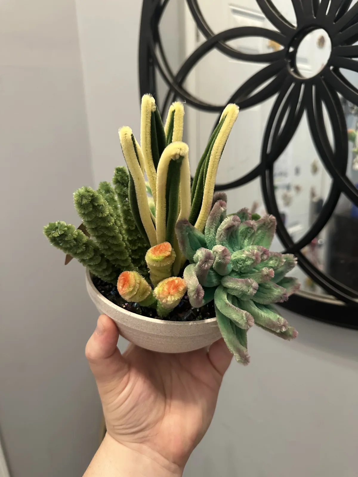 A bowl of wire succulents in greens and soft pinks