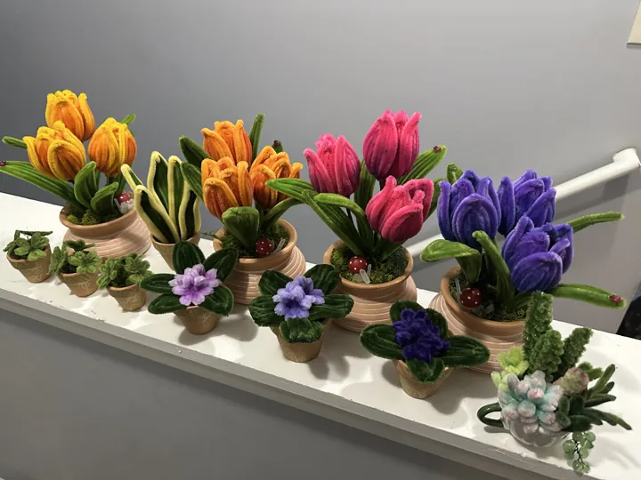 A row of wire tulips in small pots